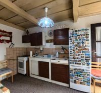 Rustic kitchen in a family house with wooden decor and nostalgic decorations.