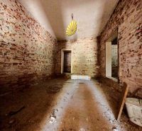 Brick walls and bare floor in the interior of a family house.