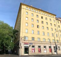 The yellow building on Odborárske Square in Bratislava - Staré Mesto with shops on the ground floor.