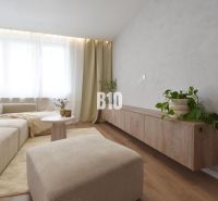 Comfortable living room with a light sofa, wooden decor flooring, 4-room apartment.