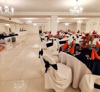 A festively decorated room with adorned tables and a Christmas tree in hotels and guesthouses.