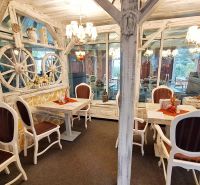 Traditional interior of hotels and guesthouses with chandeliers and rustic decor.