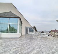 Outdoor terrace in hotels and guesthouses in Veľký Lapáš with white furniture.