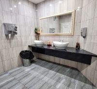 A bathroom with two sinks and a large mirror in hotels and guesthouses.