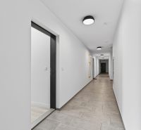 The hallway of an apartment building with white walls on Labutia Street in Bratislava, Petržalka.