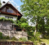 A cottage in Banská Bystrica with a terrace and green surroundings, ideal for relaxation.