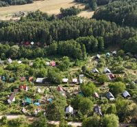Aerial view of a cottage area surrounded by forests near Banská Bystrica.