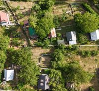 A cottage in the Banská Bystrica area, surrounded by gardens and trees, offers peaceful nature.