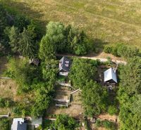 A cottage in Banská Bystrica surrounded by trees and greenery in a natural setting.