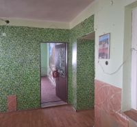 Interior of a family house with floral wallpaper and wooden decor flooring.