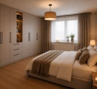 Bedroom in a family house with a bed, built-in wardrobes, and a floor with a wooden decor.