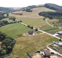 Land with residential plots near Laski Street in Vrbovce, green fields and houses.