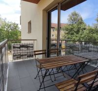 A balcony with wooden seating in a 2-room apartment on Okružná Street, Veľký Krtíš.