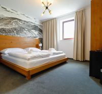 Double room in a Holiday Apartment with a decorative wall and minimalist furnishings.