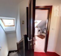 Hallway with staircase and view of the bathroom in a 2-room apartment.