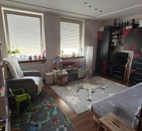 A room in a 3-room apartment with interesting ceiling lighting and a floor with a wooden decor.