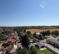 A view of the street and the surrounding landscape with fields in Levice.