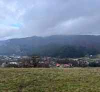 Panorama of agricultural and forest lands in Stránske with a view of the mountains and the village.