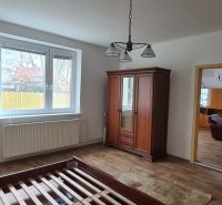 A room in a family house with furniture and a wooden decor floor.