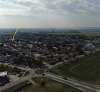 Aerial view of family houses on Krajná Street in Trnava surrounded by greenery.