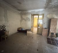 A room with furniture and a tiled stove in commercial premises on the Main Square.