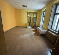 Yellow walls, tiles, large windows, cardboard boxes in commercial spaces.