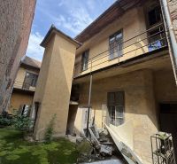 An abandoned building on the Main Square in Šahy with damaged facade and balconies.