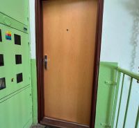 Entrance door to a 3-room apartment on Ďumbierska Street in Nitra with a wooden decor.