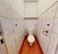 A bathroom with a toilet in a 3-room apartment, tiled with ceramic tiles.