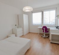 A bright bedroom with white furniture and a wooden decor floor in a 3-room apartment.