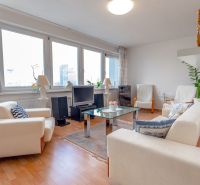 A bright living room with a sofa in a 3-room apartment, wooden decor flooring.