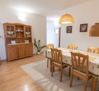 Dining area in a 3-room apartment with wooden furniture and decorations.