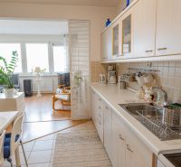 A kitchen in a 3-room apartment with a kitchen unit and entrance to the living area.
