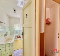 Bathroom in a family house with a bathtub, sink, and tiles.