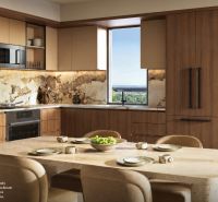 A kitchen unit with marble cladding and a table in a studio apartment.