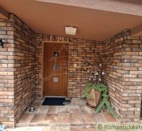 The entrance to the family house in Veľké Uherce with a brick wall and paving.