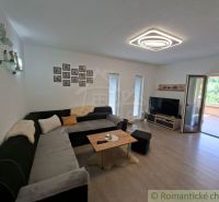 Living room of a family house with a corner sofa and access to the terrace.