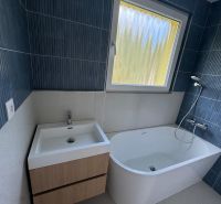 The bathroom includes a bathtub, a sink, and a window in a three-room apartment.