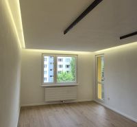 A room with a wooden floor decor and a large window in a 3-room apartment.