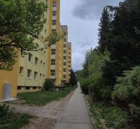 Apartment building and sidewalk surrounded by greenery on Moskovská Street in Banská Bystrica - Fončorda.