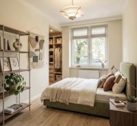 A bedroom in a 3-room apartment with a bed, shelves, and a floor with a wooden decor.