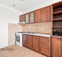 A kitchen in a 2-room apartment with a kitchen unit and a floor with a wooden decor.