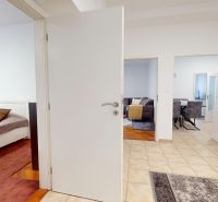 Interior of a 3-room apartment with light walls, tiles, and transitions to rooms.