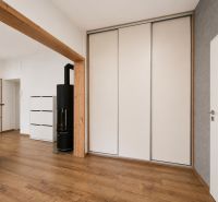 Interior of a 2-room apartment with a wooden decor floor and a built-in wardrobe.