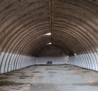 Warehouses and halls with arched ceilings and industrial appearance.