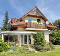 A family house in Mojš with a balcony, a glassed-in veranda, and a well-maintained garden.