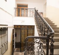 A staircase with a metal railing in the premises of a commercial space.