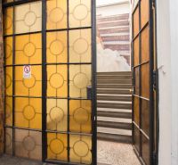 Glass doors leading to the staircase in commercial premises with a historical feel.