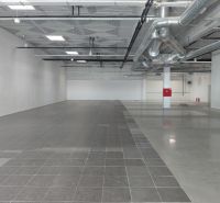 Commercial premises with gray tiles and spacious interior, suitable for construction in Bratislava.