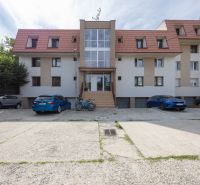 Apartment building on Orviský kút street in Piešťany, with cars and bicycles in front of it.